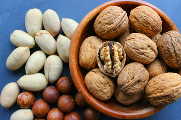 Walnuts close-up in a wooden bowl on a wooden table.healthy lifestyle, diet, vegetarianism.