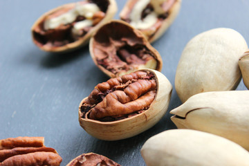 Pecan nuts on a wooden table close-up. Healthy food, healthy lifestyle, diet, vegetarianism.