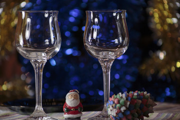 Two glasses for champagne on Christmas table.