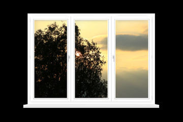 White window with sunset beyond isolated on black background. View from window