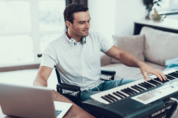 Disabled Man Composing Song with Electric Piano