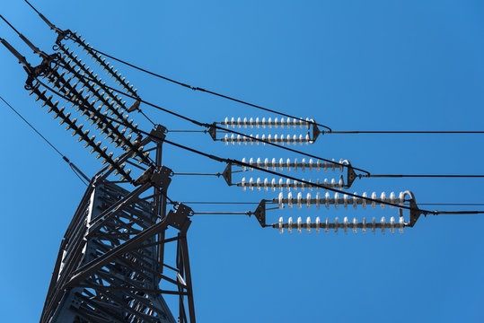 Detail of an electrical pylon on a blue sky