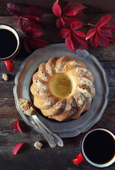 Homemade Kouglof cake, coffee and autumn red leaves