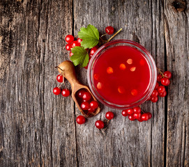 Viburnum oculus. Guelder rose on wooden background.Viburnum berries in wooden scoop.Viburnum souse