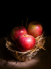 Fresh red apples on rustic background