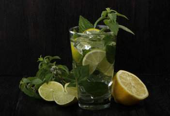 mojito with lemon, mint and ice isolated on wooden background
