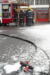 Fototapeta premium fire-fighter fighting building fire 