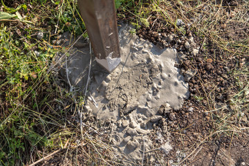 Concrete in the ground for the fence