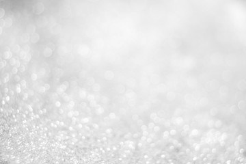 Abstract of Bright and sparkling bokeh background. silver and diamond dust bokeh blurred lighting from glitter texture