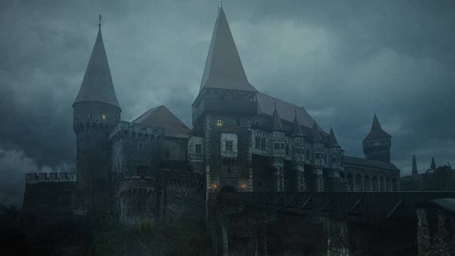 Old medieval castle in a stormy night. Corvin Castle, Romania