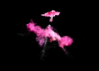 Colorful explosions of powder paint and flour combined  together explode in front of a black background to give off fantastic  multi colored cloud forms.