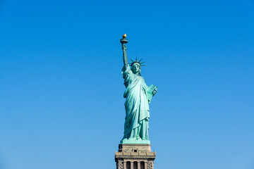 The Statue of Liberty in New York City isolated on on a blue sky background