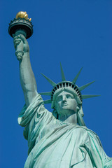 Fototapeta na wymiar Statue of Liberty front close up on a blue sky background New York City