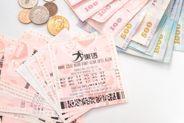Taipei, Taiwan - 7 Oct 2018: Closeup of Taiwanese currency & Taiwan lottery tickets: Big Lotto.