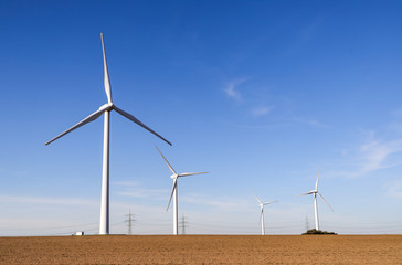 Wind turbines generating electricity with blue sky