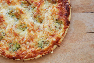 Cheese pizza on wooden table