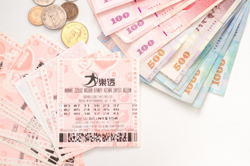Taipei, Taiwan - 7 Oct 2018: Closeup of Taiwanese currency & Taiwan lottery tickets: Big Lotto.
