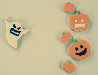 Fresh delicious homemade decorated halloween cookies sweets on dark wooden background, concept of halloween party, copy space(text space), top view, blank for text.