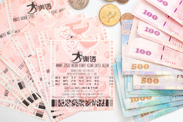 Taipei, Taiwan - 7 Oct 2018: Closeup of Taiwanese currency & Taiwan lottery tickets: Big Lotto.