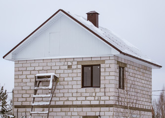 Country house cottage in the snow in winter