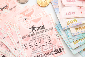 Taipei, Taiwan - 7 Oct 2018: Closeup of Taiwanese currency & Taiwan lottery tickets: Big Lotto.