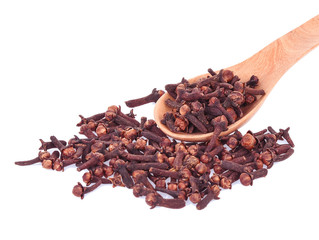 dry cloves in spoon on white background