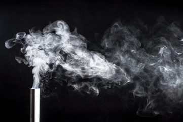 Smoke from a pipe on a black background