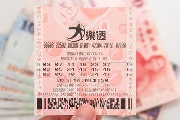 Taipei, Taiwan - 7 Oct 2018: Closeup of Taiwanese currency & Taiwan lottery tickets: Big Lotto.