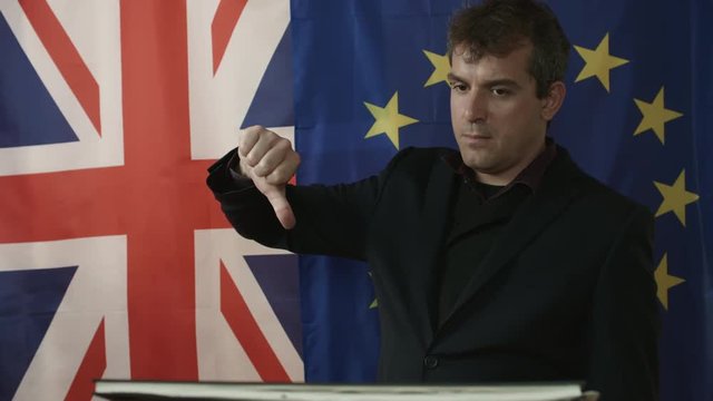 Middle Aged Trade Negotiator Points At Documentation and Shows Negative Gesture