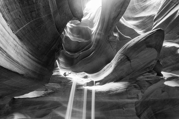 Beam of sand is flowing off the rocks in the interior of the narrow walls of the winding Antelope Canyon, Arizona © jovannig