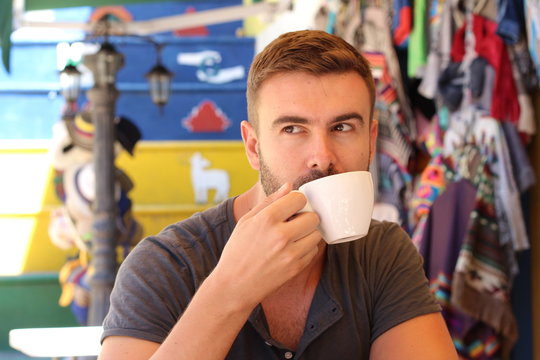 Handsome man drinking a cup of coffee