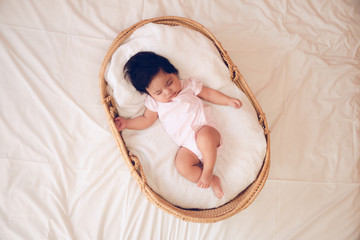 Baby sleeping in a basket