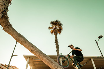 Guy riding and jumping with a bmx bike