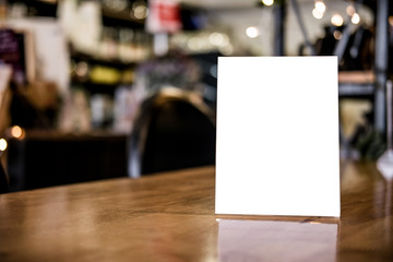 Naklejka na ściany i meble Mock up blank menu frame on table in coffee shop stand for your text of display your product