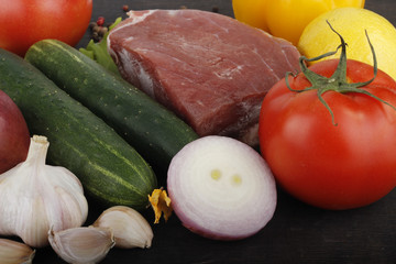 vegetables and meat on wooden background