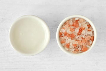 Homemade face scrub made out of Himalayan pink salt and coconut oil on wooden background