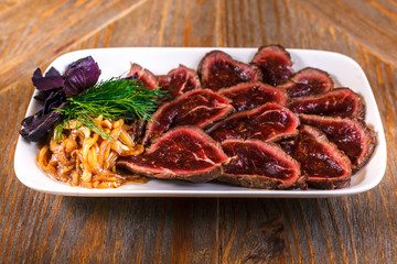 Meat steak beef with fresh vegetables, herbs on white dish