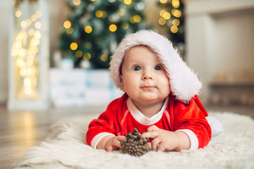 Christmas morning, baby dressed as Santa Claus