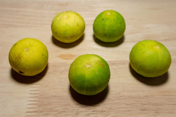fresh green limes on a wooden table