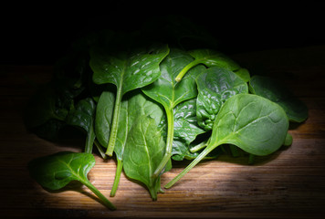 Fresh spinach leaves on rustic background