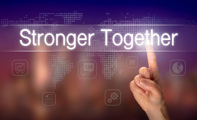 A hand selecting a Stronger Together business concept on a clear screen with a colorful blurred background.