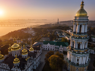 Obraz premium Beautiful view to Kiev Pechersk Lavra, rider Dnipro and The Motherland Monument. Aerial drone photo. Fog and sunrise light. European capital. Most visited palces