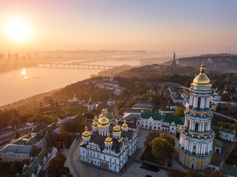 Most inetersting places of Kiyv Ukraine. Kiev Pechersk Lavra. Aerial drone photo. View to rider Dnipro and The Motherland Monument. Fog and sunrise light. Amazing view