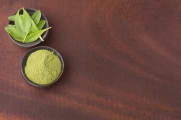 Obraz na płótnie Canvas Green leaves and stevia powder - Stevia rebaudiana. Top view