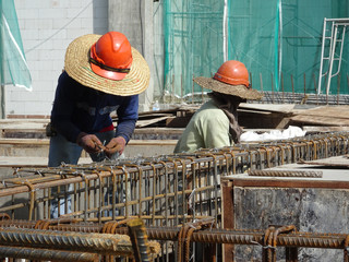 KUALA LUMPUR, MALAYSIA -MARCH 29 14, 2016: Construction workers fabricating steel reinforcement bar...