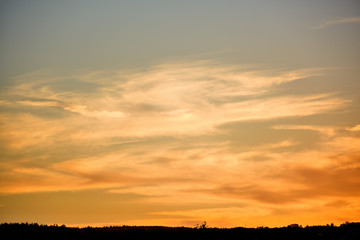Bright clouds lit by the setting sun which descended in the evening twilight.