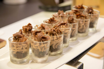 Chocolate mousse, which is in a glass transparent glass