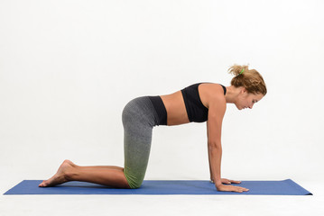 Beautiful young woman doing yoga on white background