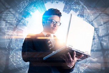 The double exposure image of the business man using a laptop computer during sunrise overlay with cityscape image. The concept of modern life, business, city life and internet of things.