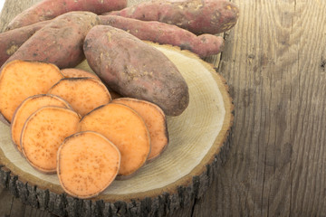 heap of sweet potato isolated on wooden background